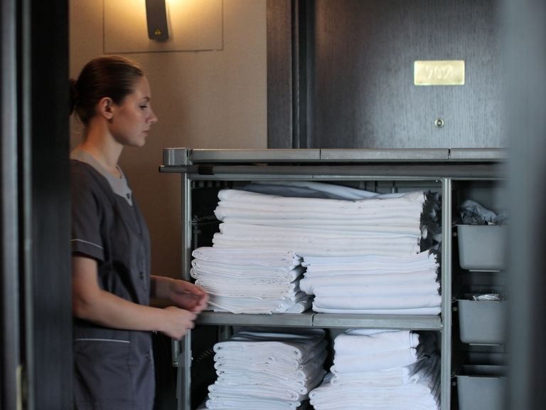 a hotel staff preparing a room