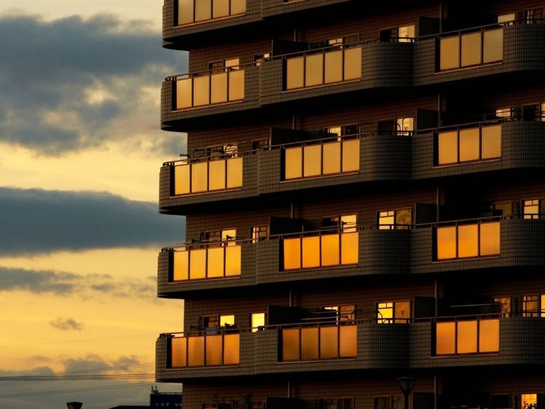 a view of a highrise apartment during sunrise